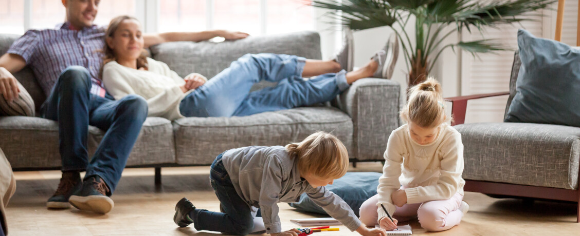 Young family lounging in their living area